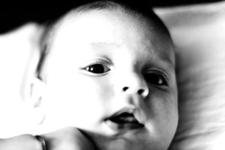 Sleeping newborn baby boy in bed. Newborn baby