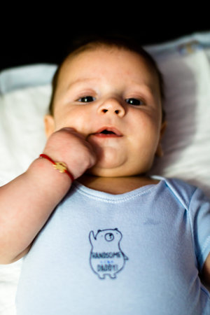 Sleeping newborn baby boy in bed. Newborn baby