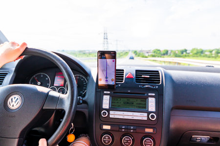 Using waze maps application on smartphone on car dashboard, Bucharest, Romania, 2022のeditorial素材