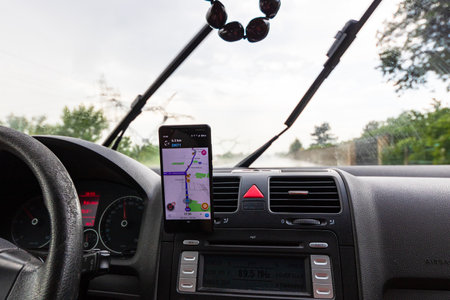 Using waze maps application on smartphone on car dashboard, Bucharest, Romania, 2022のeditorial素材