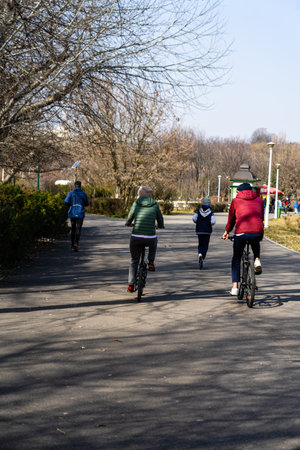 Riding a bicycle on the city streets. Commute to work in Bucharest, Romania, 2022のeditorial素材