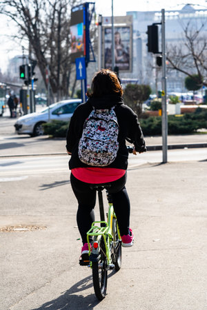 Riding a bicycle on the city streets. Commute to work in Bucharest, Romania, 2022の写真素材