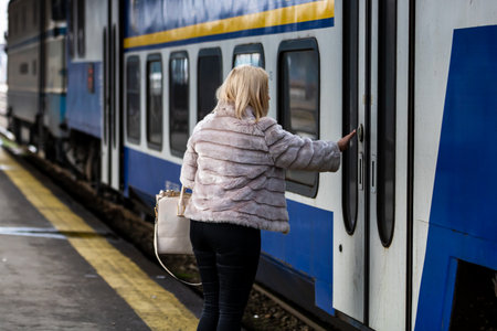 Tourist pulling luggage. Commuters walking at railroad station platform in Bucharest, Romania, 2022の写真素材