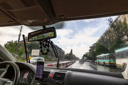 Using waze maps application on smartphone on car dashboard, Bucharest, Romania, 2022のeditorial素材