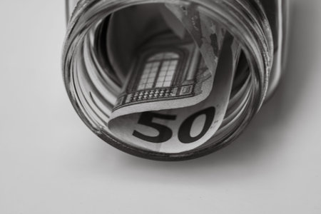 Composition with saving money banknotes (50 EURO) in a glass jar. Concept of investing and keeping...