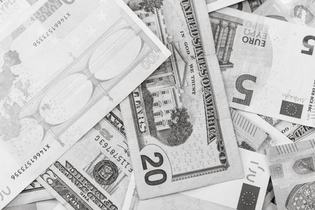 World money concept, detail on EURO and US dollar banknotes, EURO and US currency background,...