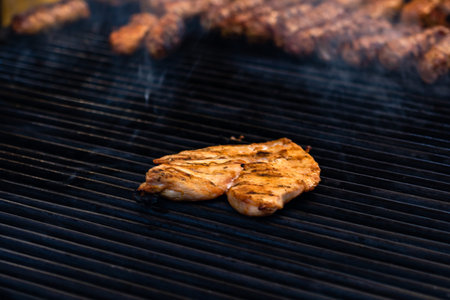 Grilling tasty food on barbecue. Steak, sausages on grill at food festival