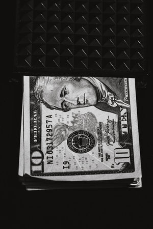 10 Dollars banknotes in a black wallet isolatedの写真素材