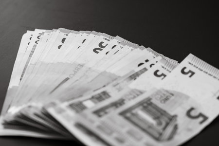 Blurred money on the table, EURO on black table. Business concept stack of moneyの写真素材