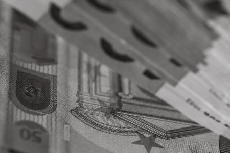Selective focus on detail of EURO banknotes. Counting or giving EURO banknotes. World money concept, inflation and economy conceptの写真素材