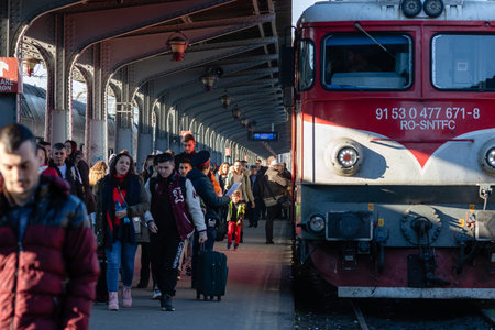 People getting on and off the train at Bucharest North Railway Station (Gara de Nord) in Bucharest,...