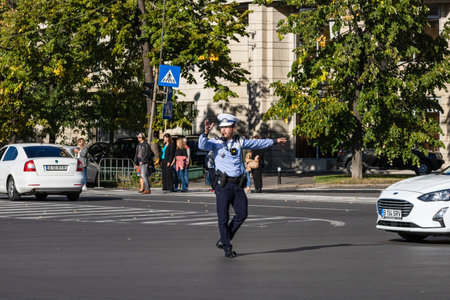 Police agent, Romanian Traffic Police (Politia Rutiera) directing traffic. Rush hour in Bucharest, Romania, 2022のeditorial素材