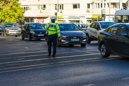 Police agent, Romanian Traffic Police (Politia Rutiera) directing traffic. Rush hour in Bucharest, Romania, 2022のeditorial素材