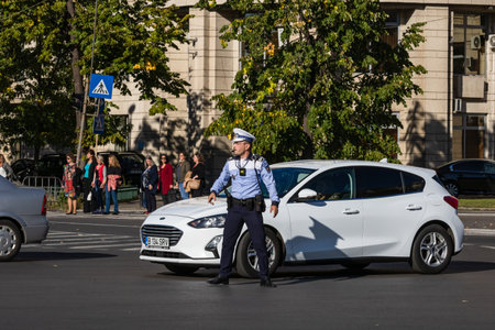 Police agent, Romanian Traffic Police (Politia Rutiera) directing traffic. Rush hour in Bucharest, Romania, 2022のeditorial素材