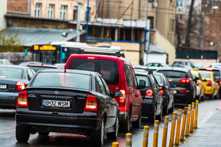 Car traffic at rush hour in downtown area of the city. Car pollution, traffic jam in the morning and evening in the capital city of Bucharest, Romania, 2020のeditorial素材