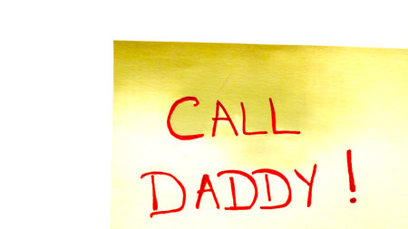 Call daddy handwriting text close up isolated on yellow paper with copy space.の写真素材