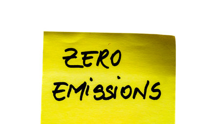 Zero emissions handwriting text close up isolated on yellow paper with copy space.の写真素材