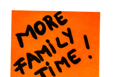 More family time handwriting text close up isolated on orange paper with copy space.の写真素材