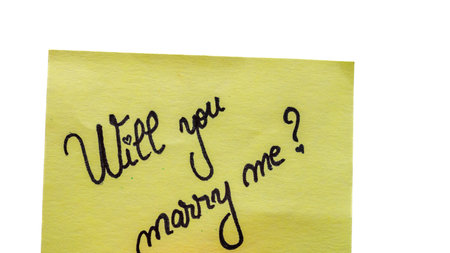 Will you marry me handwriting text close up isolated on yellow paper with copy space.の写真素材