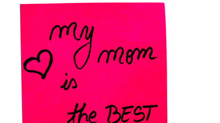 My mom is the best handwriting text close up isolated on pink paper with copy space. Writing text on memo post reminderの写真素材