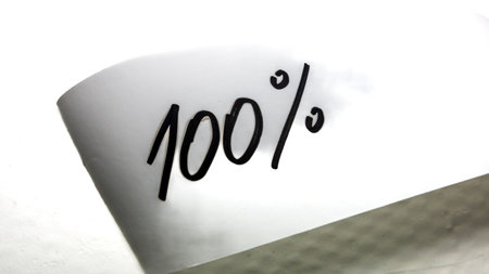Writing 100 percent on white label on white background.の写真素材