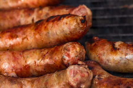 Close up on details of homemade sausages on barbecue grill. Barbecue, grill and food concept.の写真素材