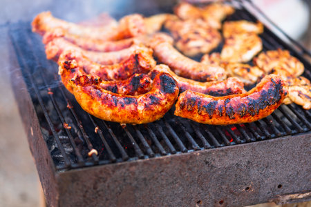 Grilling sausages and pork chops on barbecue grill. BBQ in the gardenの写真素材