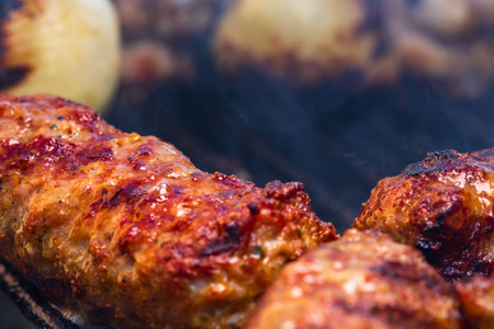 Traditional Romanian food Meat Balls "mici" on grill. Tasty meat balls on barbeque, pork meat on charcoal barbecueの写真素材