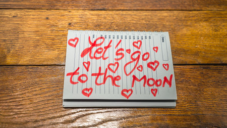 Let`s go to the moon, writing love text on paper, lovely message. Text on spiral agenda. Romantic,...