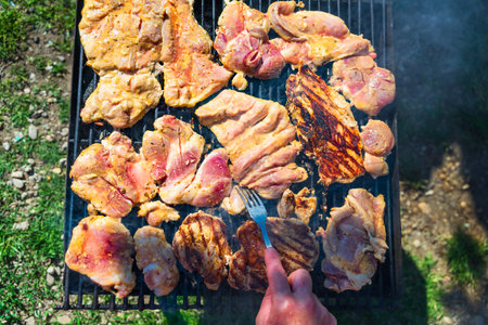 Raw steak on a charcoal barbeque. Top view of camping tasty barbecue, food concept, food on grill and detail of food on the grillの写真素材