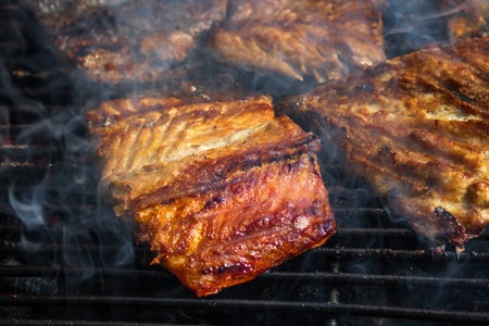 Grilled mackerel fish with smoke on a charcoal barbecue grill.の写真素材