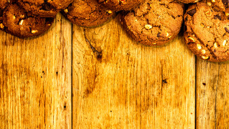 Biscuits on wooden table. Chocolate cookies on the table, breakfast concept. Top view with copy spaceの写真素材