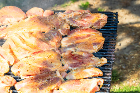 Raw steak on a charcoal barbeque. Top view of camping tasty barbecue, food concept, food on grill and detail of food on the grillの写真素材
