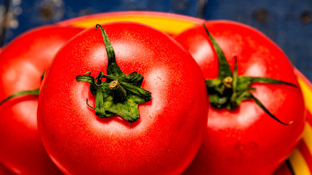 Close up of ripe red tomato, tomatoes background.の写真素材