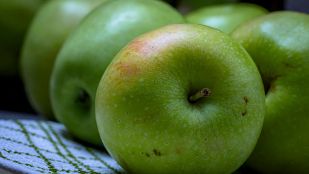 Wooden crate with ripe green apples on wooden table.の写真素材