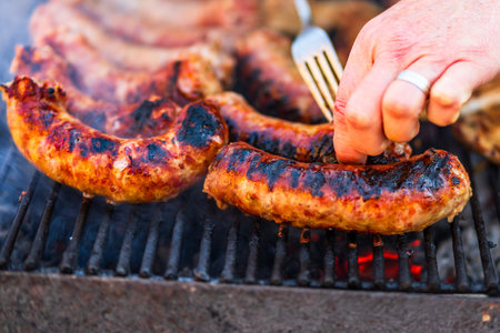 Grilling sausages and pork chops on barbecue grill. BBQ in the gardenの写真素材