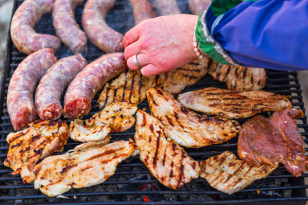 Grilling sausages and pork chops on barbecue grill. BBQ in the gardenの写真素材