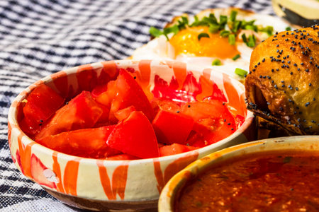 Close up of traditional rustic bowl with chopped tomatoes isolatedの写真素材