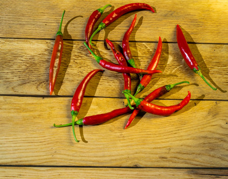 Red chili peppers on a wooden board.の写真素材