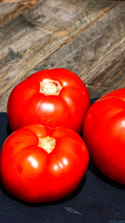 Close up of fresh ripe tomatoes isolated in a rustic composition,の写真素材