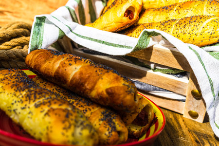 Sausage in puff pastry on a rustic table. Tasty hot dog in pastryの写真素材