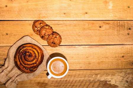 Fresh puff pastry on wooden table. Coffee, food and breakfast concept. Desserts, fresh pastries, biscuits and coffee. Top view and copy spaceの写真素材