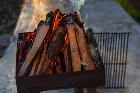 Burning wood chips to form coal. Barbecue preparation, fire before cooking.の写真素材