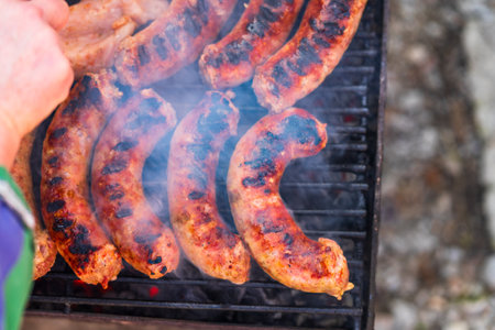 Grilling sausages and pork chops on barbecue grill. BBQ in the gardenの写真素材