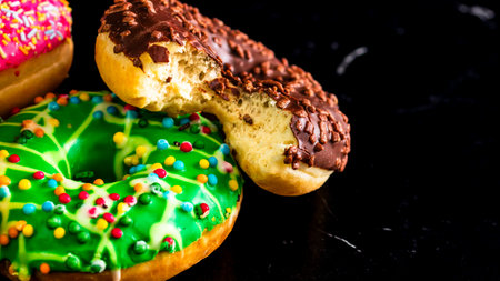 Glazed donuts with sprinkles isolated. Close up of colorful donuts.の写真素材