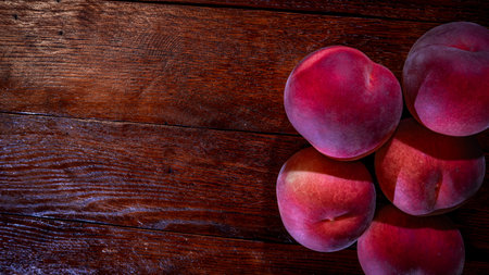 Fresh juicy peaches on rustic wooden tableの写真素材