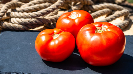 Close up of fresh ripe tomatoes isolated in a rustic composition,の写真素材