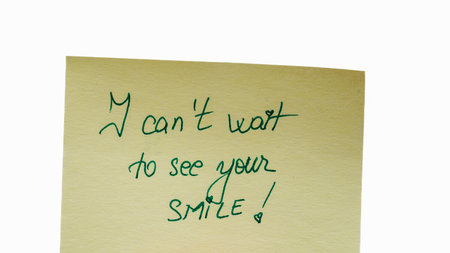 I can not wait to see your smile handwriting text close up isolated on yellow paper with copy space.の写真素材