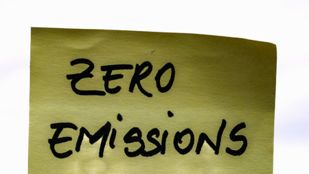 Zero emissions handwriting text close up isolated on yellow paper with copy space.の写真素材
