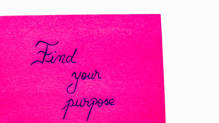 Find your purpose handwriting text close up isolated on pink paper with copy space. Writing text on memo post reminderの写真素材
